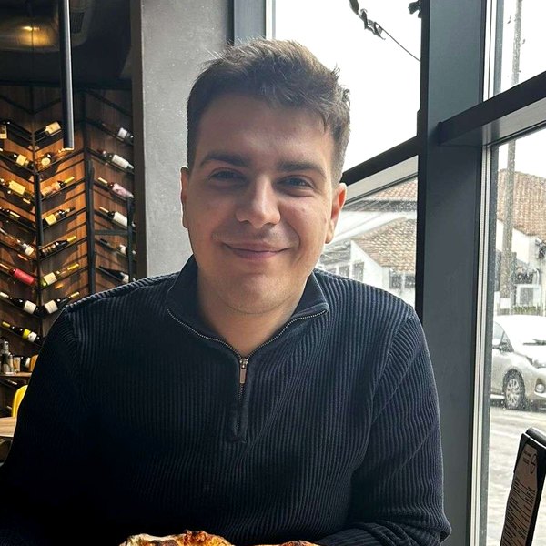 Tomi smiling at a restaurant table